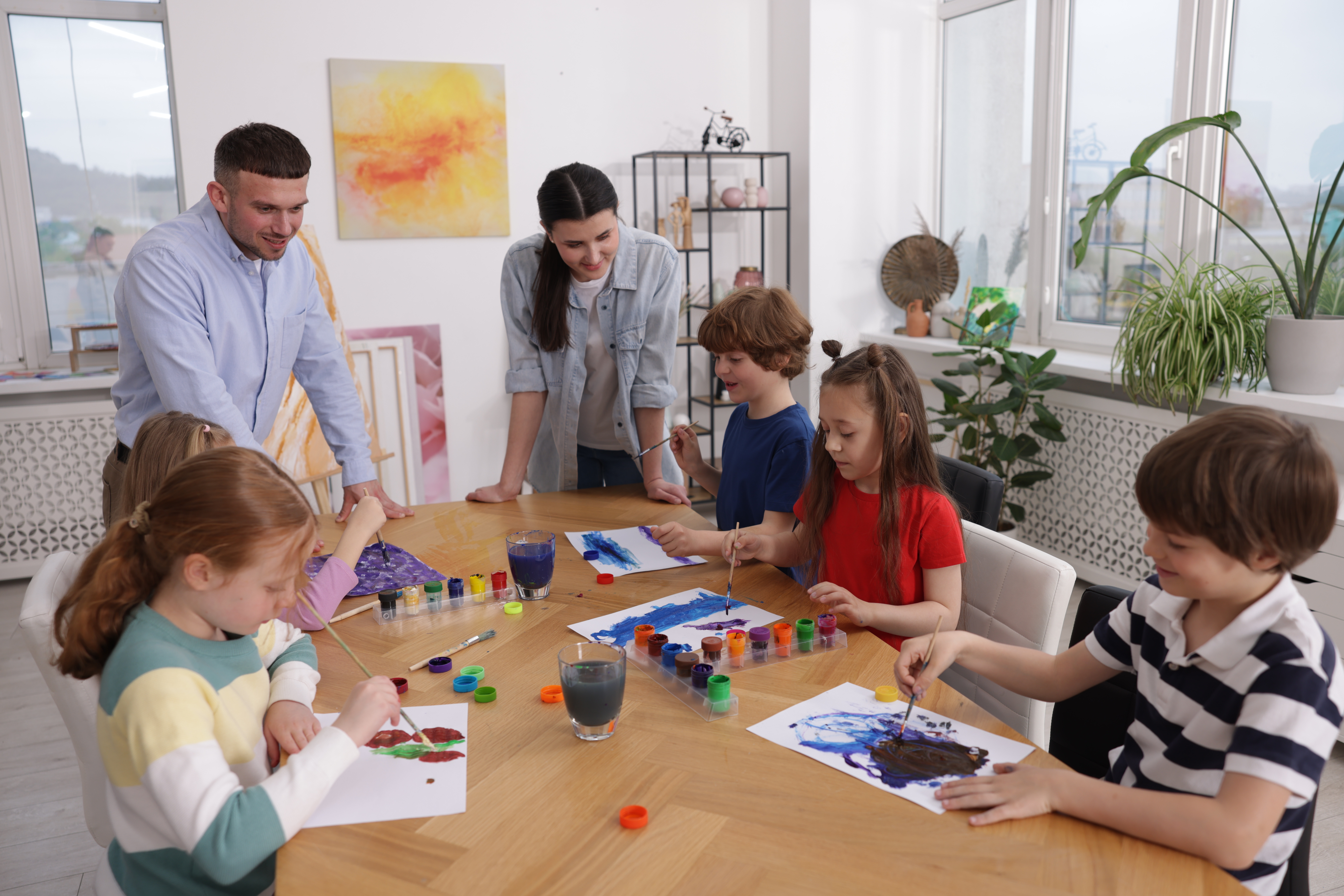 Kids with teachers at painting lesson